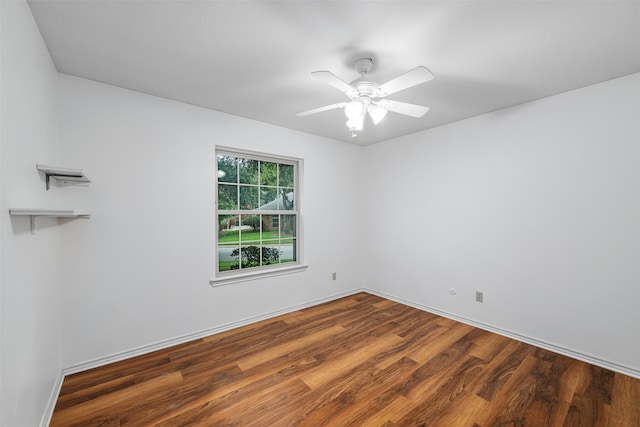 unfurnished room featuring ceiling fan and dark hardwood / wood-style floors