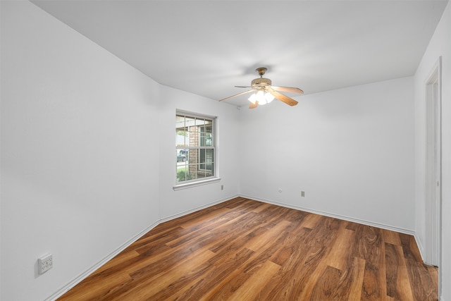 empty room featuring wood-type flooring and ceiling fan