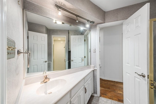 bathroom with vanity and hardwood / wood-style floors