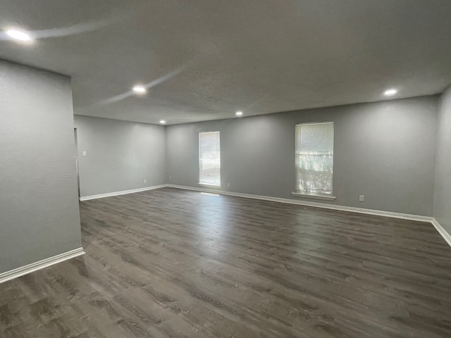 spare room with dark hardwood / wood-style floors