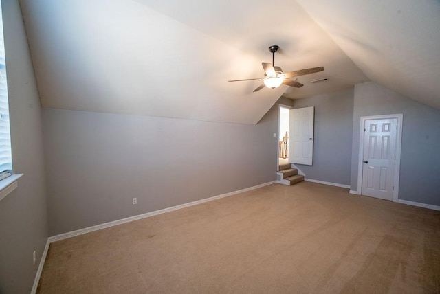 bonus room with ceiling fan, lofted ceiling, and light carpet