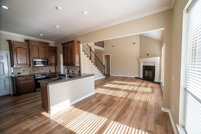 kitchen featuring decorative backsplash, stainless steel appliances, hardwood / wood-style floors, and sink