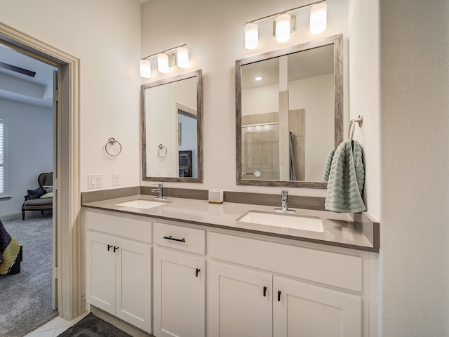 bathroom featuring walk in shower, vanity, and tile patterned flooring