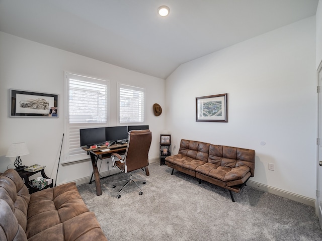 carpeted office space featuring vaulted ceiling