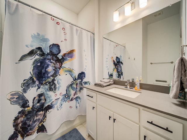 bathroom with tile patterned flooring, shower / tub combo with curtain, and vanity