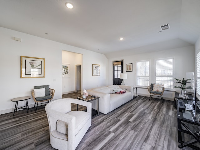 living room featuring vaulted ceiling and dark hardwood / wood-style flooring