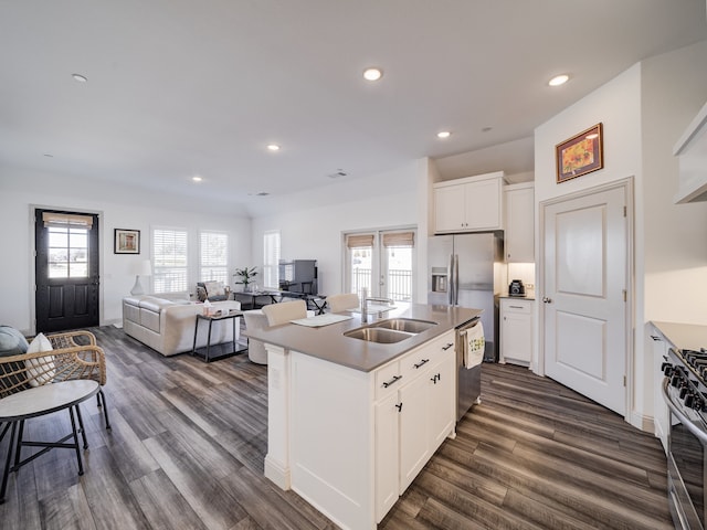 kitchen featuring white cabinets, sink, a center island with sink, stainless steel appliances, and dark hardwood / wood-style flooring