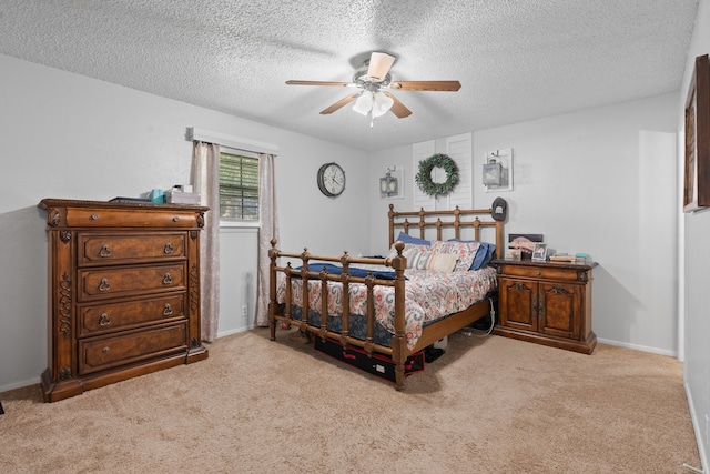 carpeted bedroom with ceiling fan and a textured ceiling