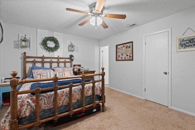 carpeted bedroom with a textured ceiling and ceiling fan