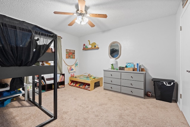 bedroom featuring ceiling fan, light colored carpet, and a textured ceiling