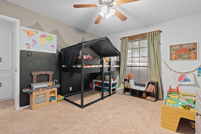 bedroom with light carpet, ceiling fan, and a textured ceiling