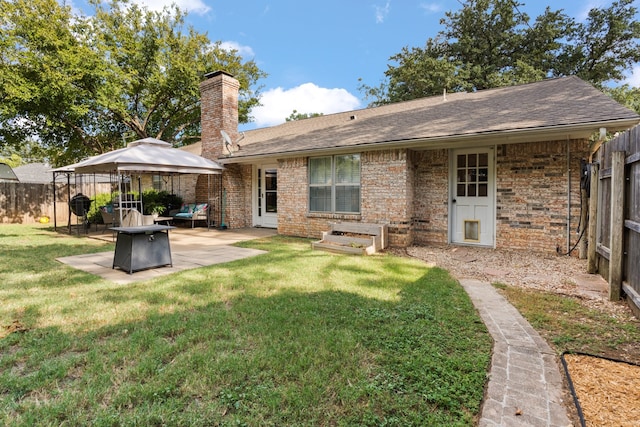 back of house with a lawn and a patio area