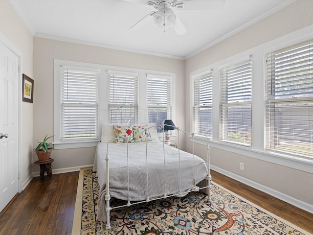 bedroom featuring ceiling fan, ornamental molding, dark hardwood / wood-style flooring, and multiple windows