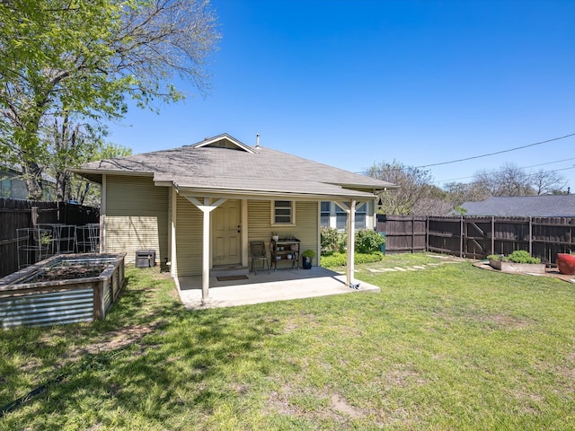 rear view of property with a yard and a patio