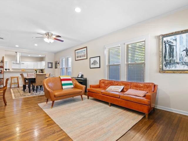 living room with hardwood / wood-style flooring, crown molding, plenty of natural light, and ceiling fan