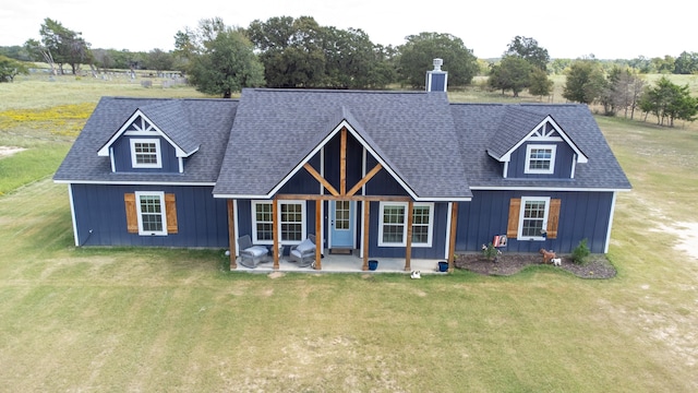 view of front of house with a patio area and a front yard