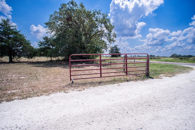 view of gate with a rural view