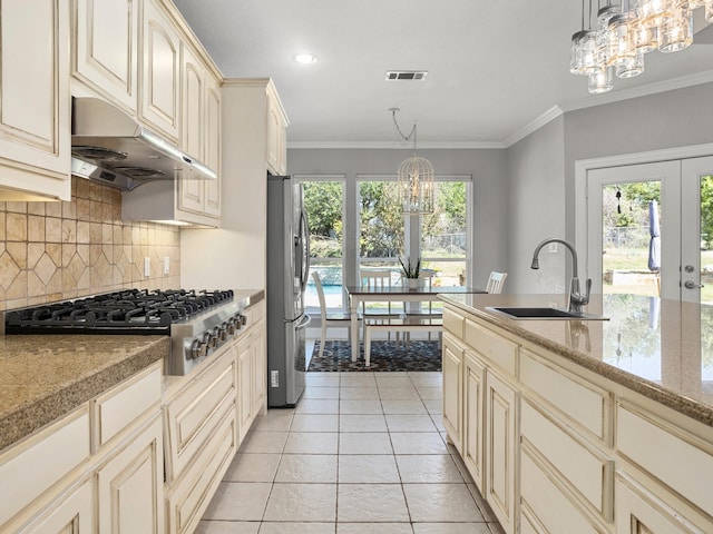 tiled dining space featuring crown molding and an inviting chandelier