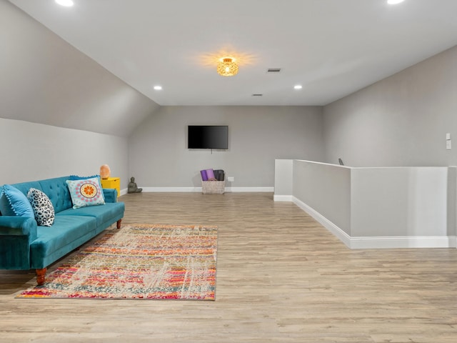 game room with light hardwood / wood-style floors and lofted ceiling