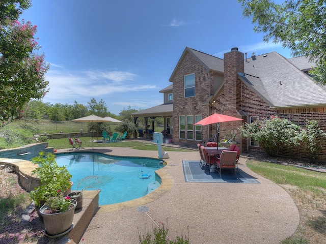 back of property featuring a yard and a patio area