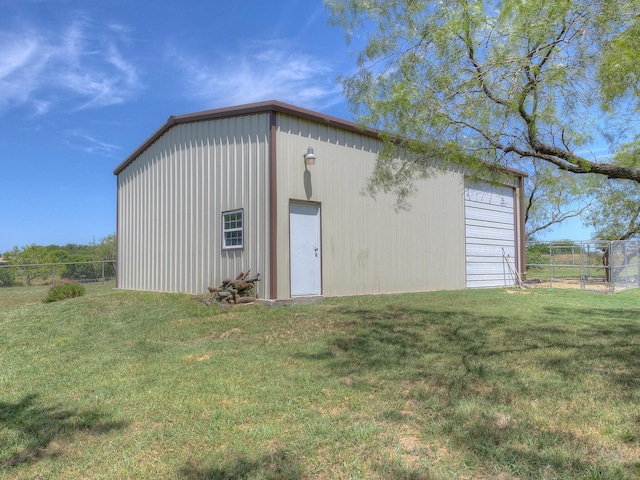 view of patio with a garage and an outbuilding