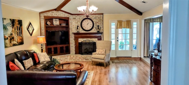 living room with a brick fireplace, light hardwood / wood-style flooring, plenty of natural light, and lofted ceiling with beams