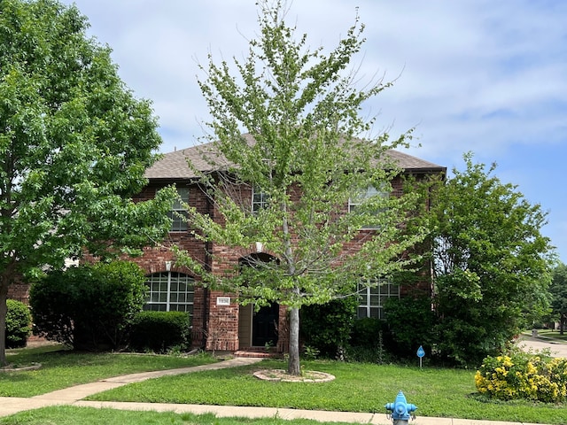 obstructed view of property featuring a front yard