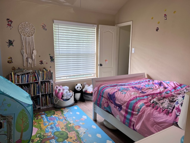 bedroom with lofted ceiling and hardwood / wood-style flooring