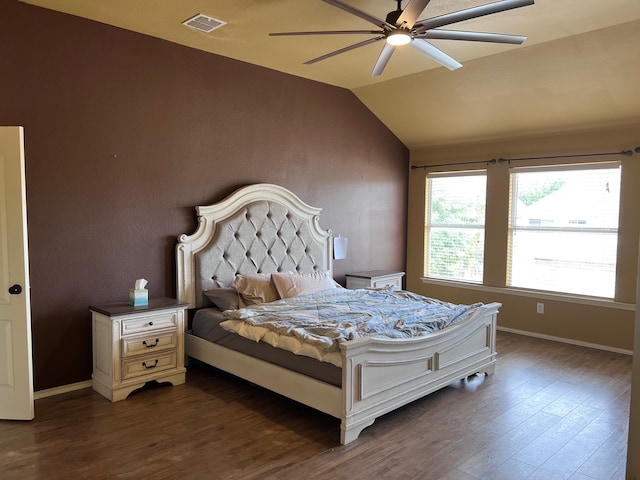 bedroom with dark hardwood / wood-style floors, vaulted ceiling, and ceiling fan