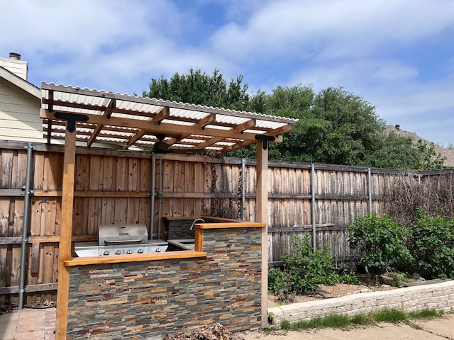 view of patio featuring grilling area, area for grilling, and a pergola