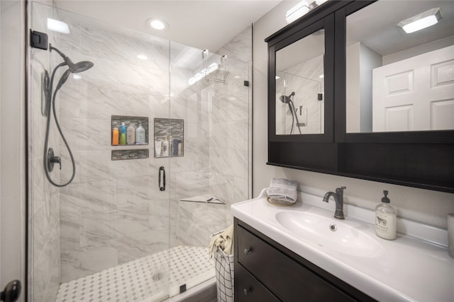 bathroom featuring vanity and a shower with shower door