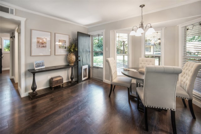 dining space featuring a notable chandelier, dark hardwood / wood-style floors, and ornamental molding