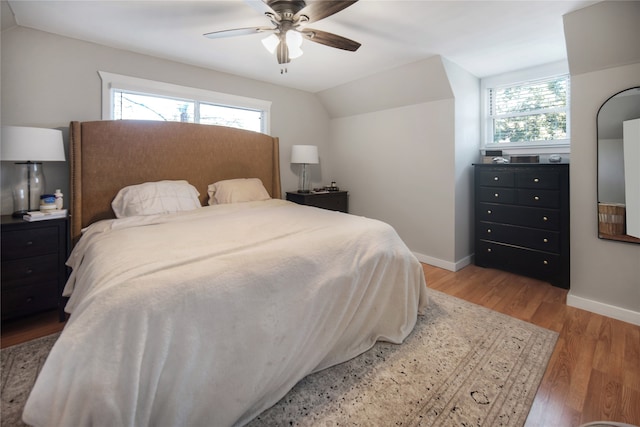 bedroom with lofted ceiling, ceiling fan, and hardwood / wood-style flooring