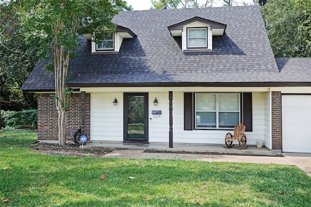 cape cod-style house with a front lawn, covered porch, and a garage