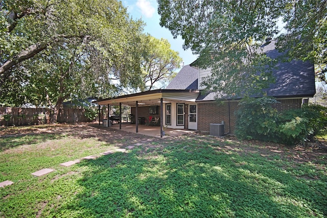 view of yard with central AC unit and a patio