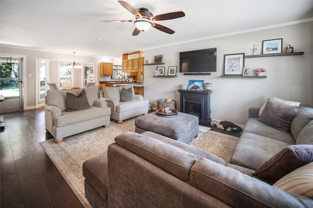 living room with ceiling fan, crown molding, and wood-type flooring