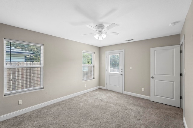 spare room with light carpet and ceiling fan