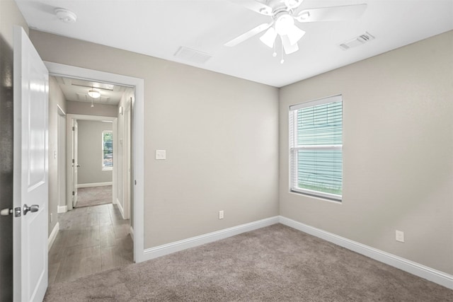 spare room with ceiling fan and carpet floors