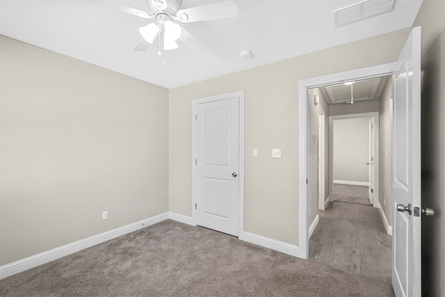 unfurnished bedroom with carpet floors and ceiling fan