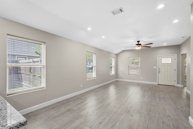 unfurnished living room featuring ceiling fan, light hardwood / wood-style flooring, and vaulted ceiling