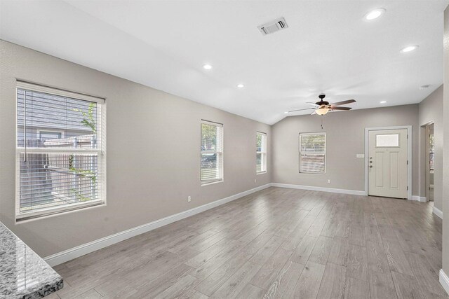 unfurnished living room with ceiling fan, baseboards, light wood finished floors, and visible vents