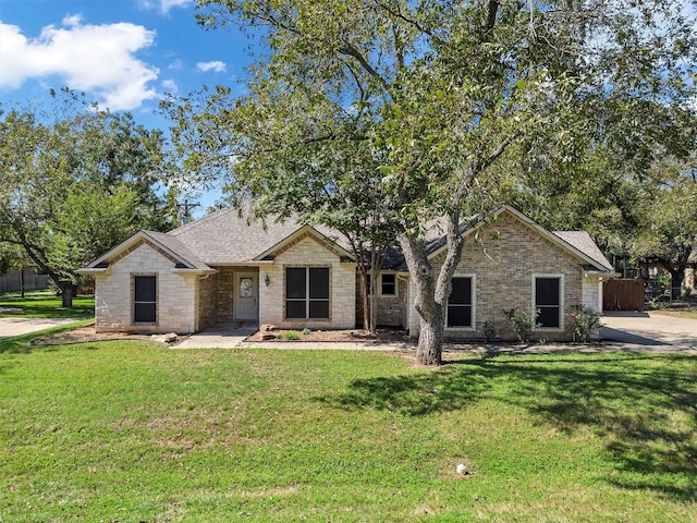 ranch-style home featuring a front yard