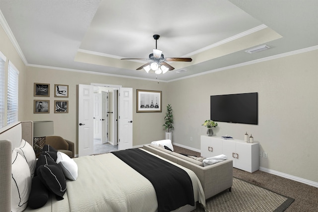 bedroom with a raised ceiling, ornamental molding, ceiling fan, and light colored carpet