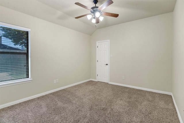 carpeted spare room with ceiling fan and lofted ceiling