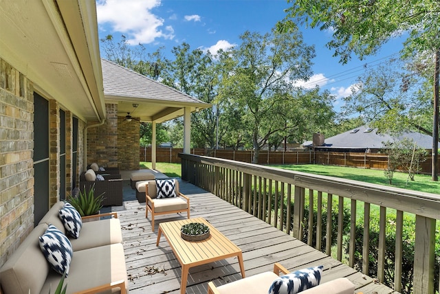 wooden deck with an outdoor hangout area and ceiling fan