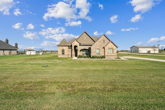 french country home featuring a front lawn