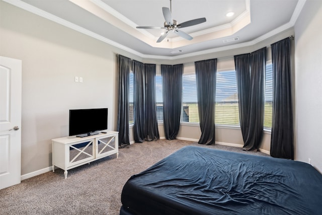 carpeted bedroom with ceiling fan, a raised ceiling, and crown molding