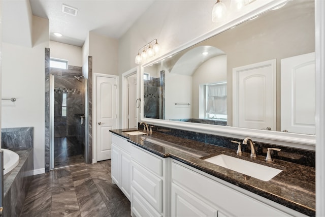 bathroom with vanity and separate shower and tub