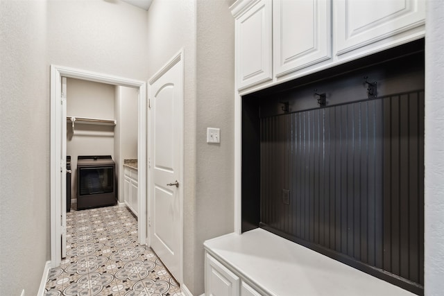 mudroom featuring washer / clothes dryer and light tile patterned flooring