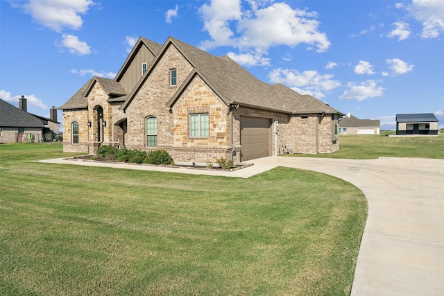 view of front of house featuring a garage and a front lawn